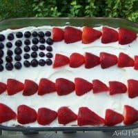 Whole wheat 4th of July flag cake decorated with blueberries and strawberries to resemble the flag.