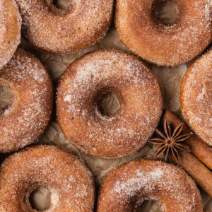 Sourdough apple cider donuts on parchment paper.