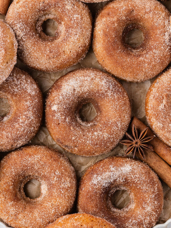 Sourdough apple cider donuts on parchment paper.