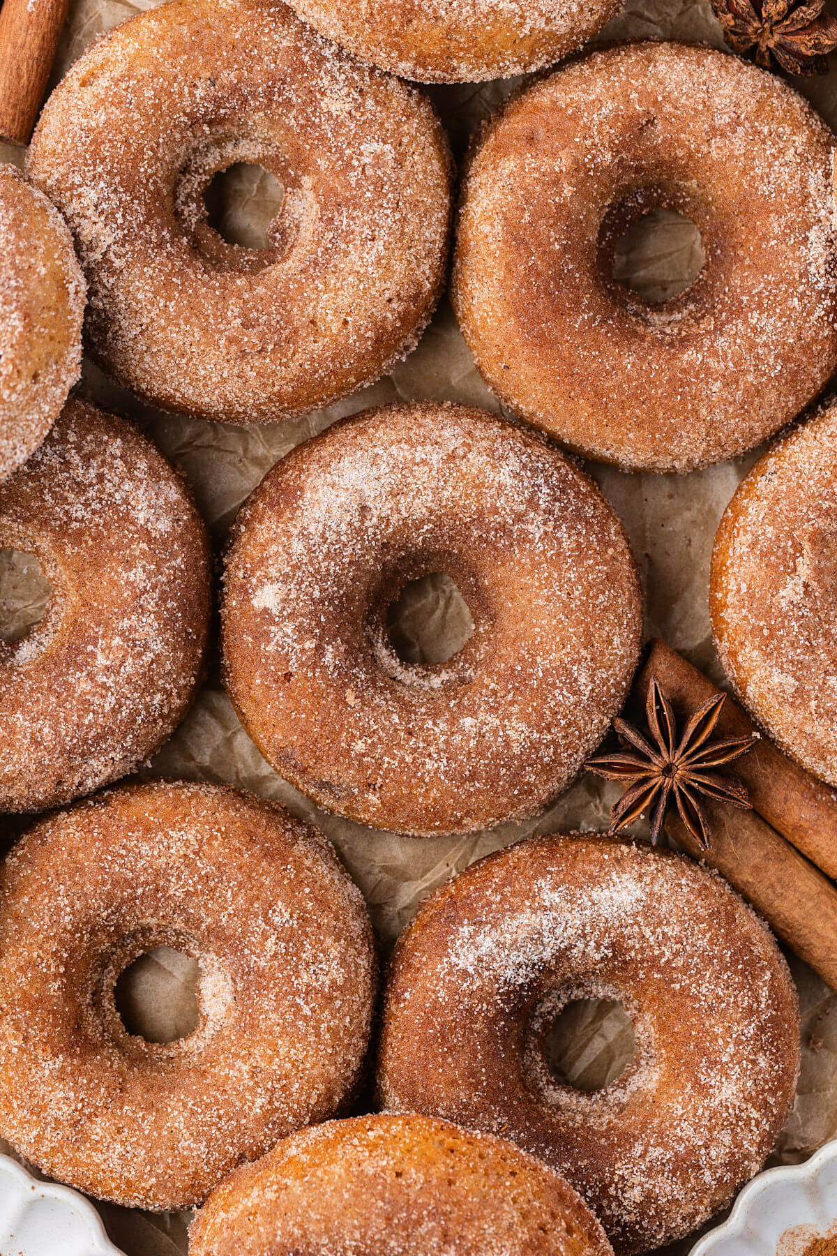Sourdough apple cider donuts on parchment paper.