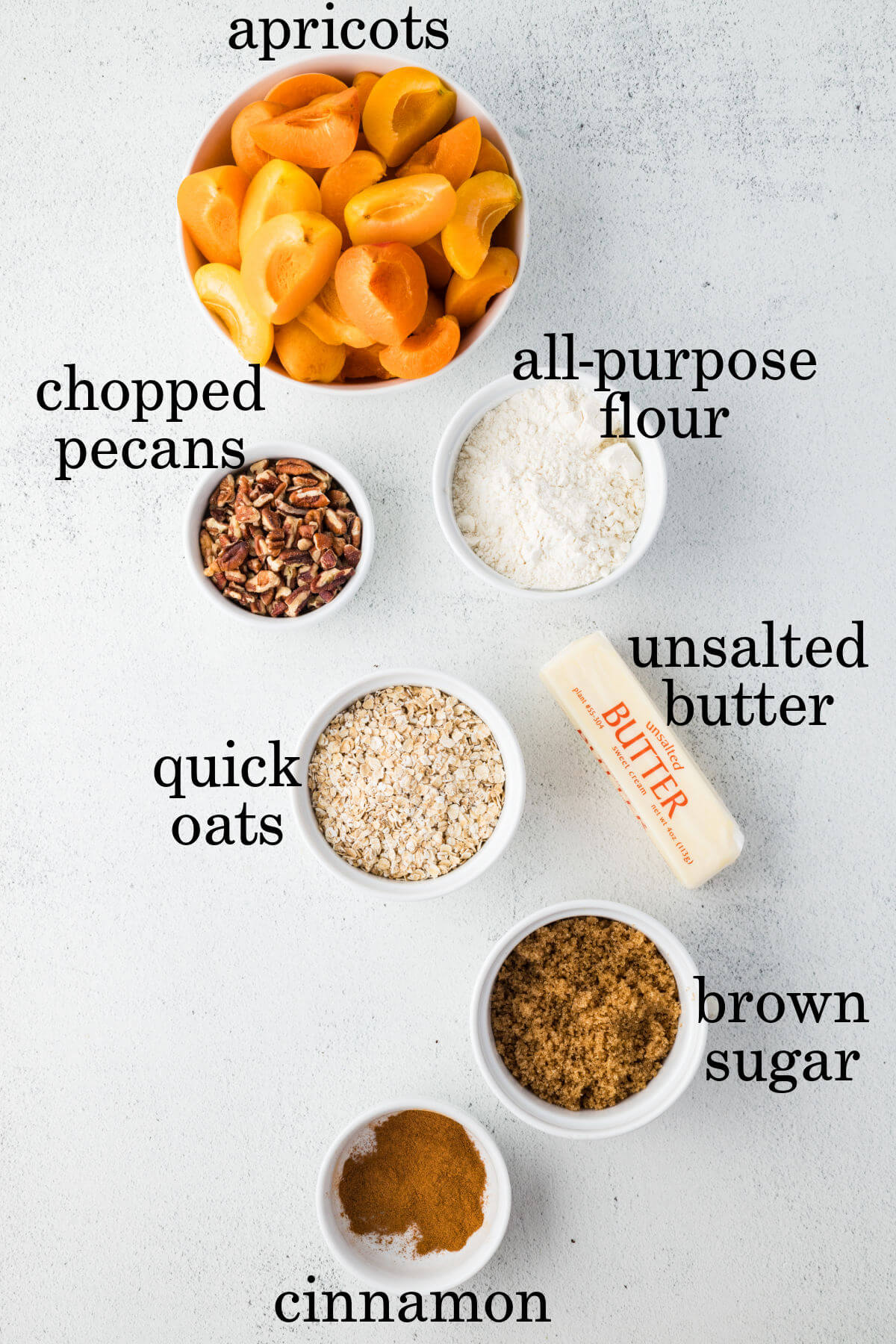 Ingredients for apple crumble in small bowls.