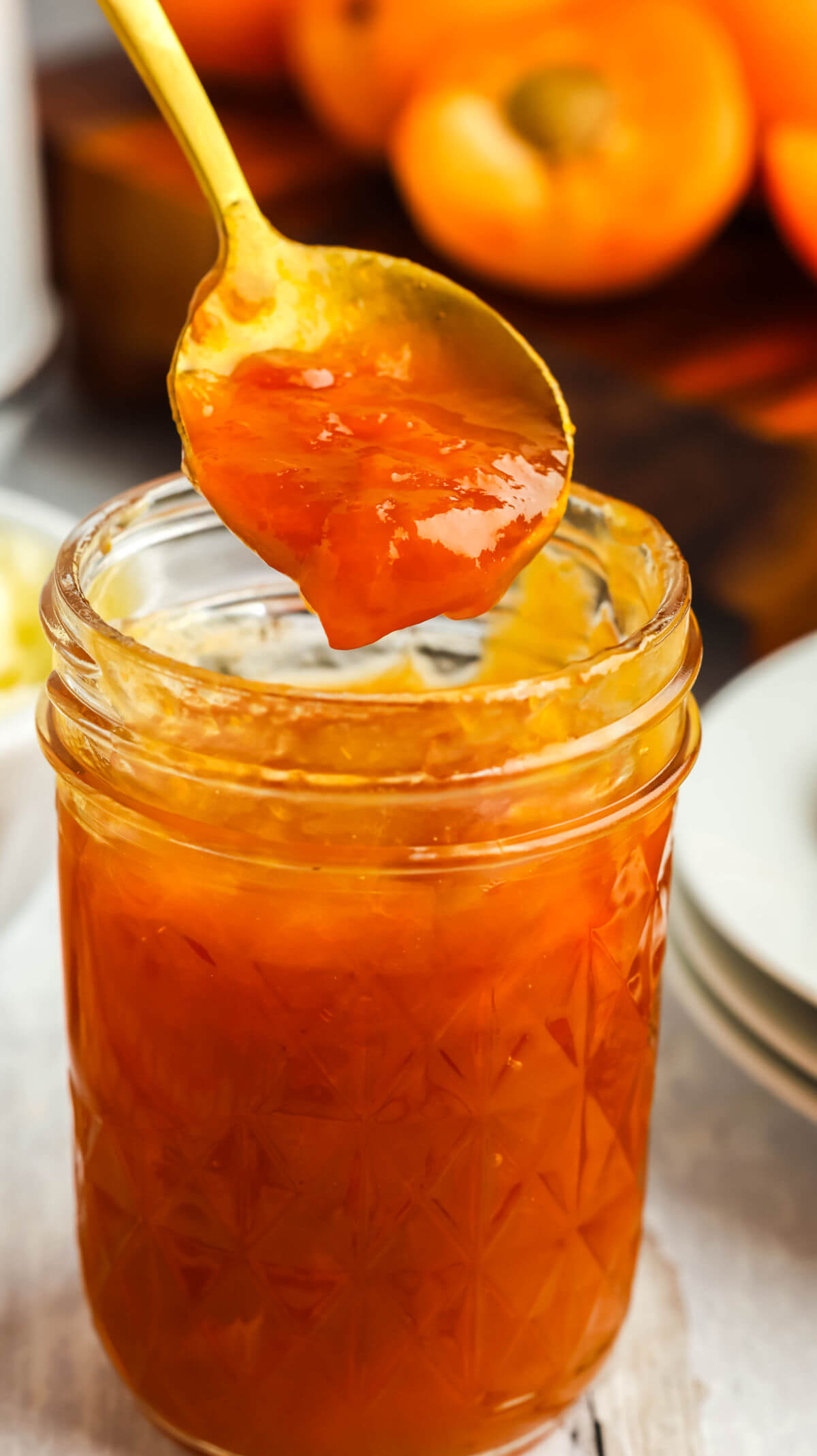 Apricot jam without pectin on a spoon.