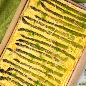 Asparagus goat cheese tart baked in a sheet pan.