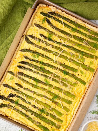 Asparagus goat cheese tart baked in a sheet pan.