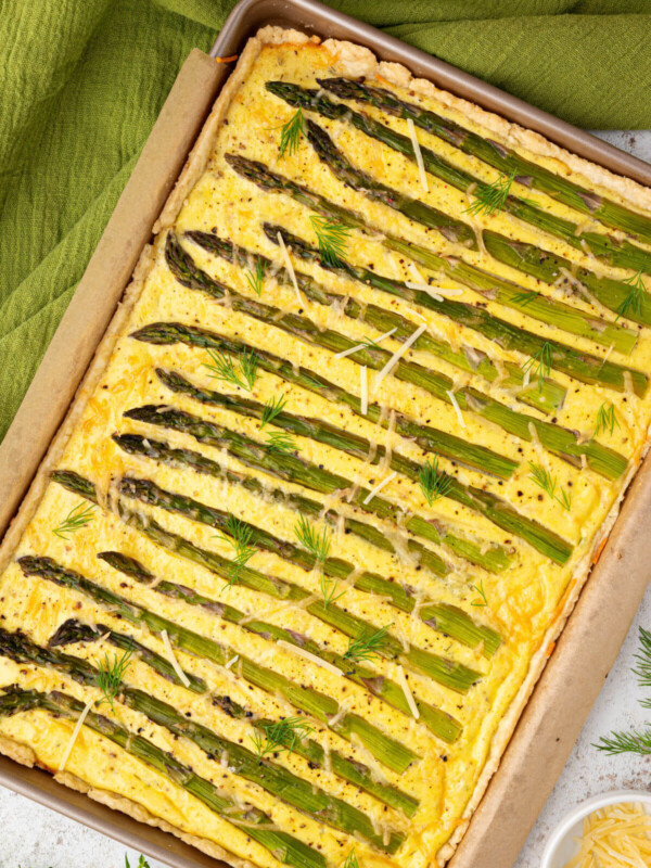 Asparagus goat cheese tart baked in a sheet pan.