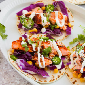 Blackened salmon tacos on a serving platter.