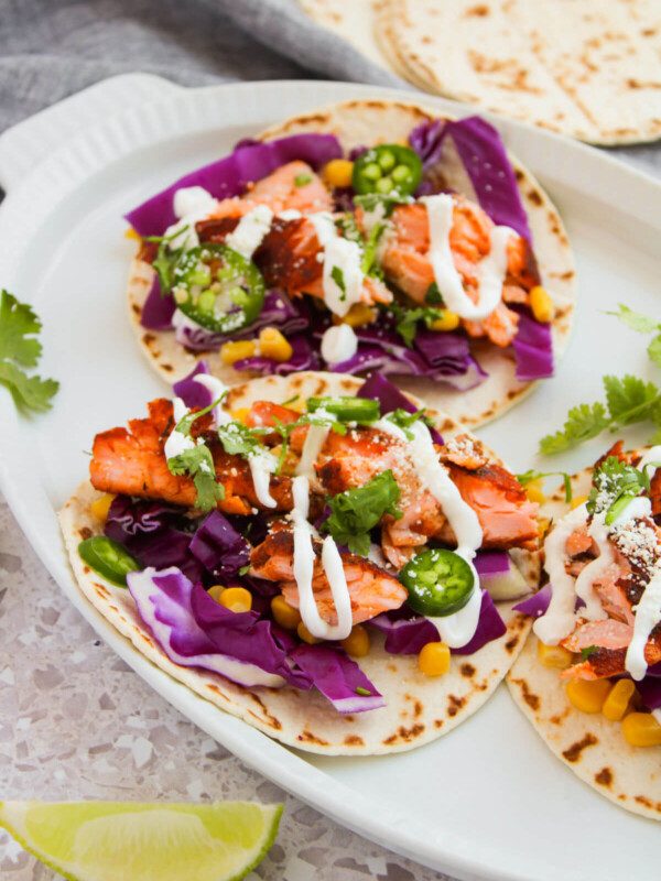 Blackened salmon tacos on a serving platter.