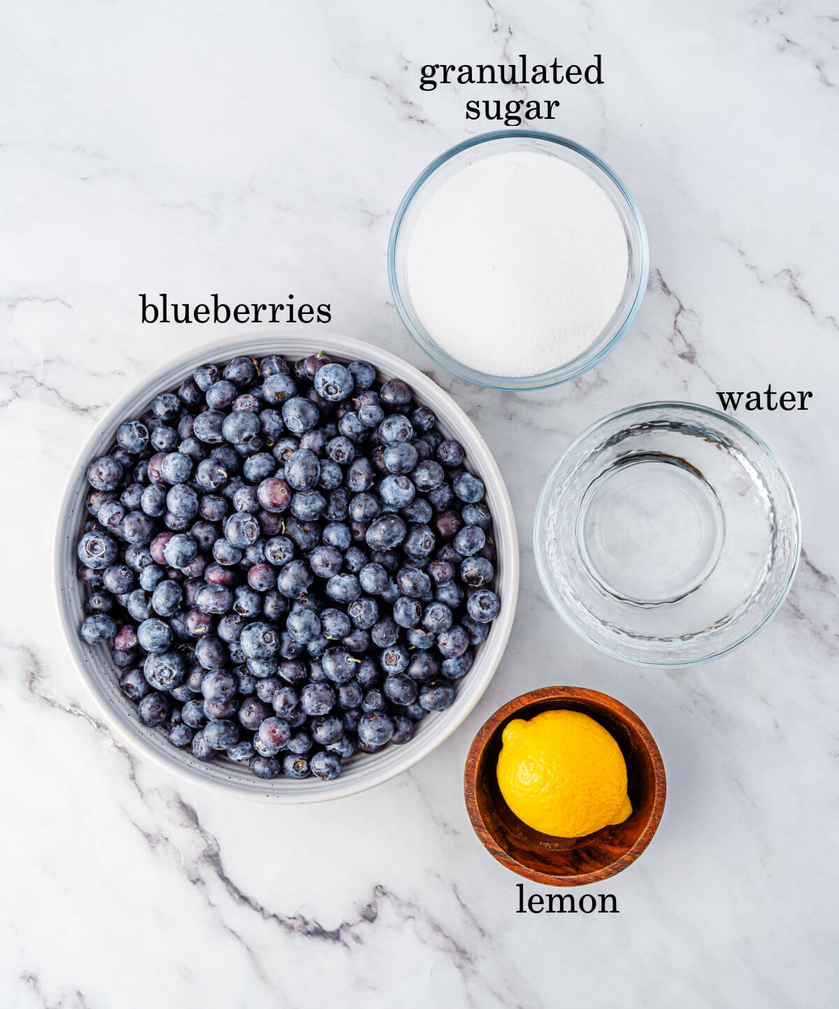 Blueberry syrup ingredients in small bowls.
