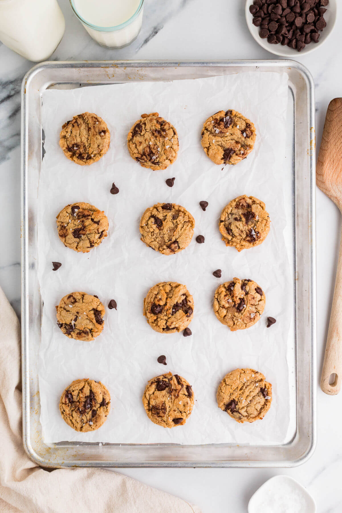 Brown butter sourdough chocolate chip cookies on a cookie sheet.