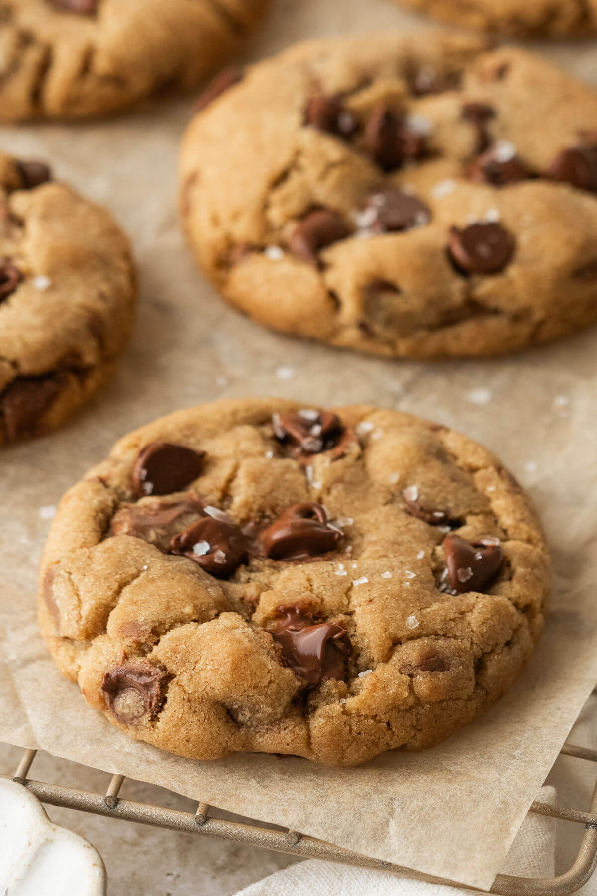 Brown butter chocolate chip cookies on a. piece of parchment paper after baking.