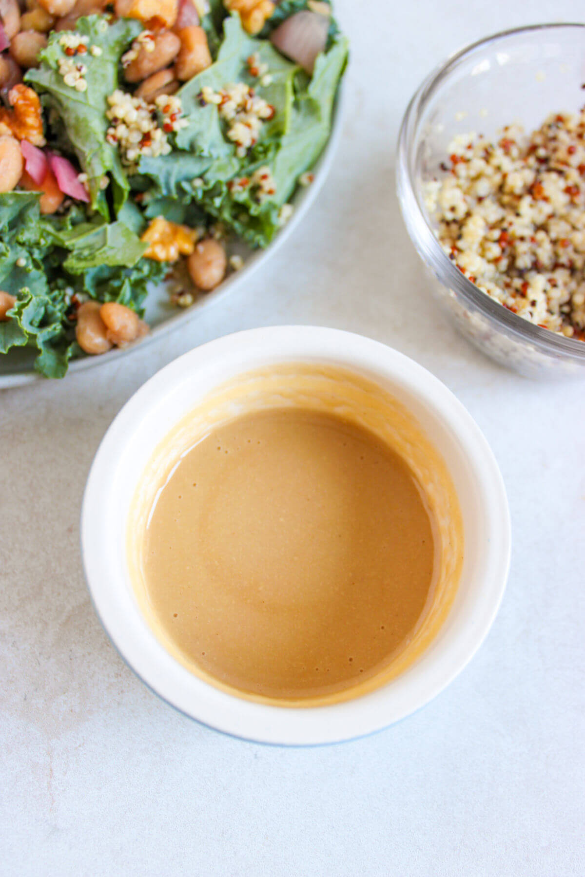 Tahini mustard salad dressing in a white bowl.
