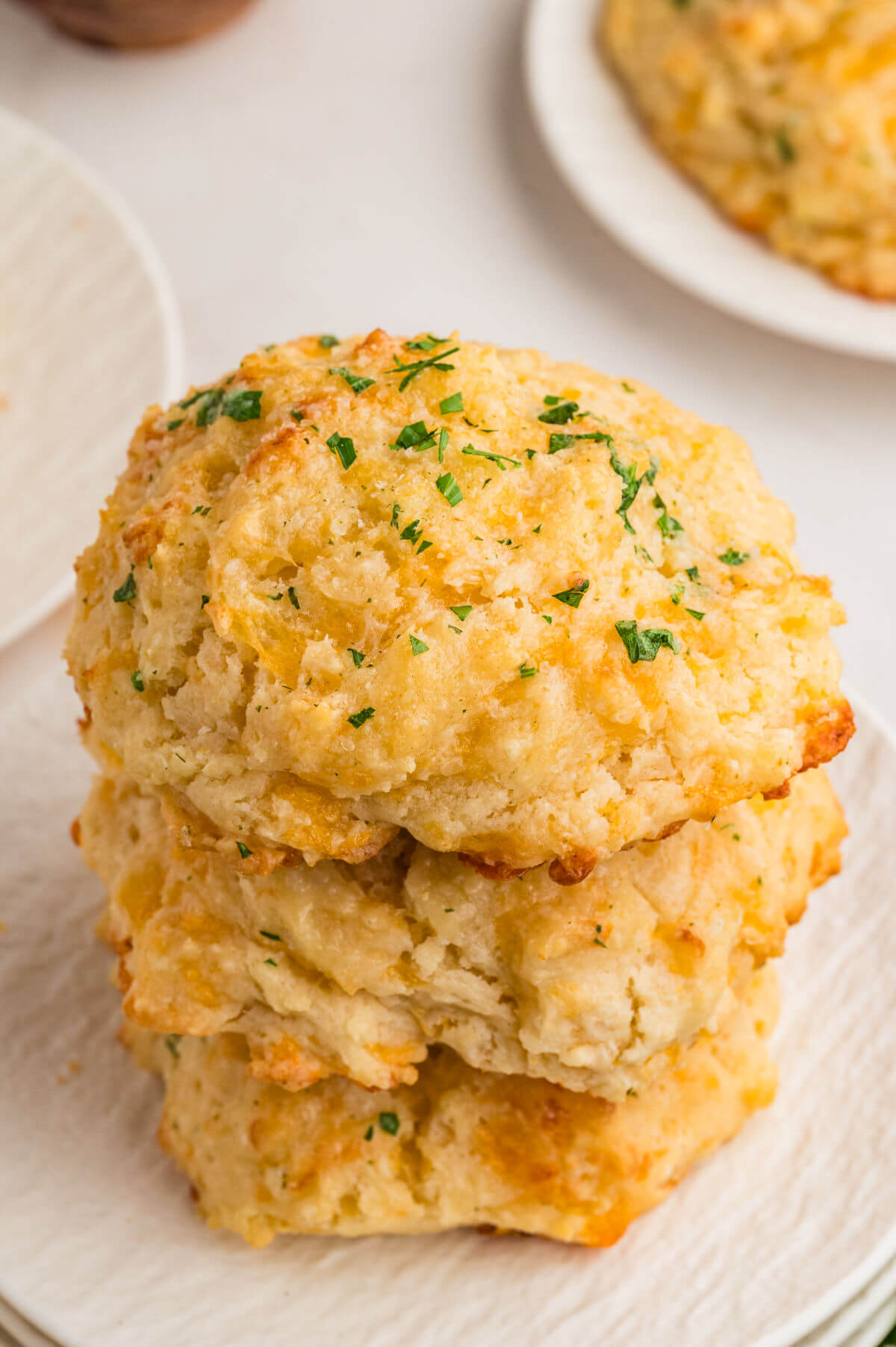 A stack of three cheesy drop biscuits.