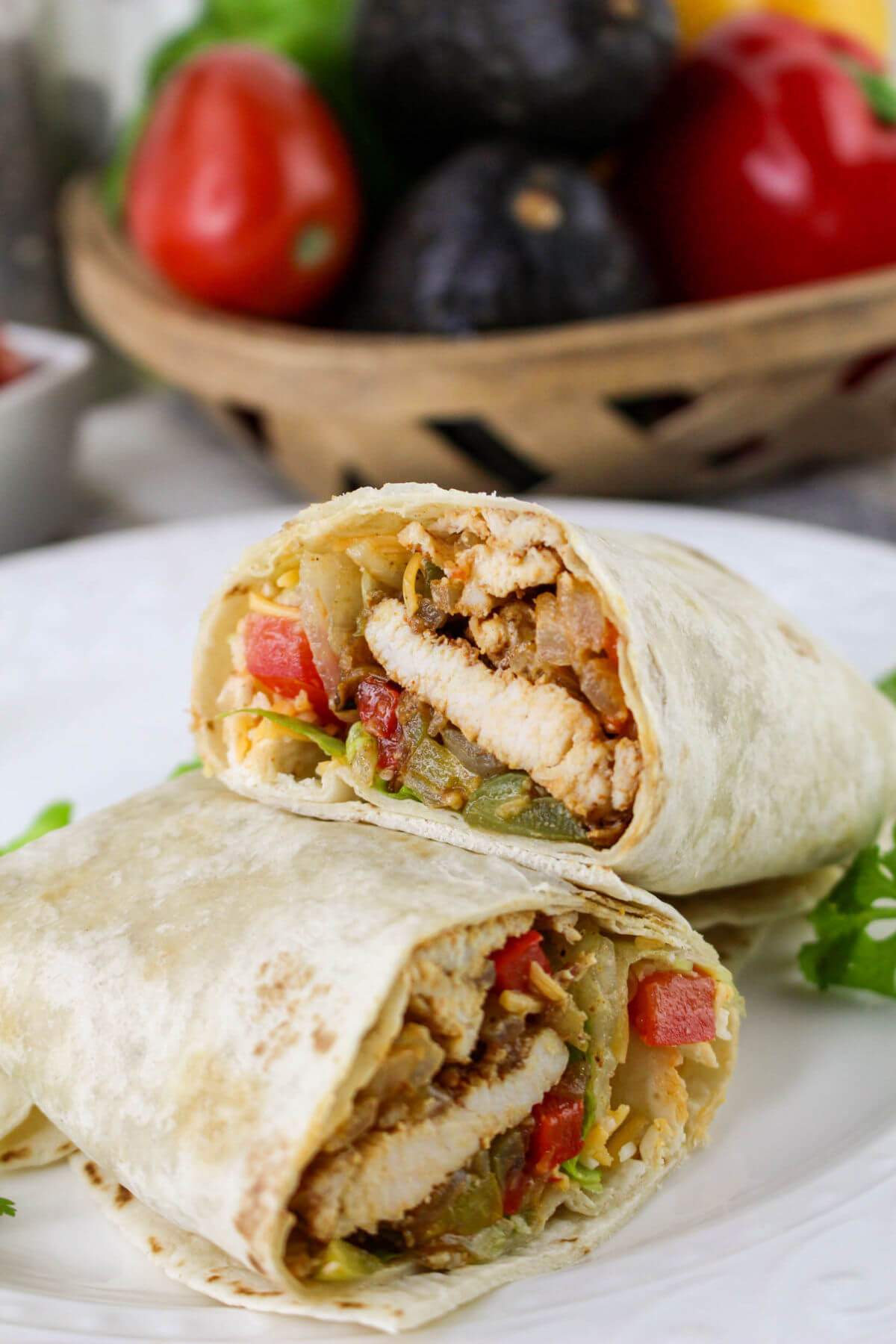 Chicken fajita wraps on a plate.