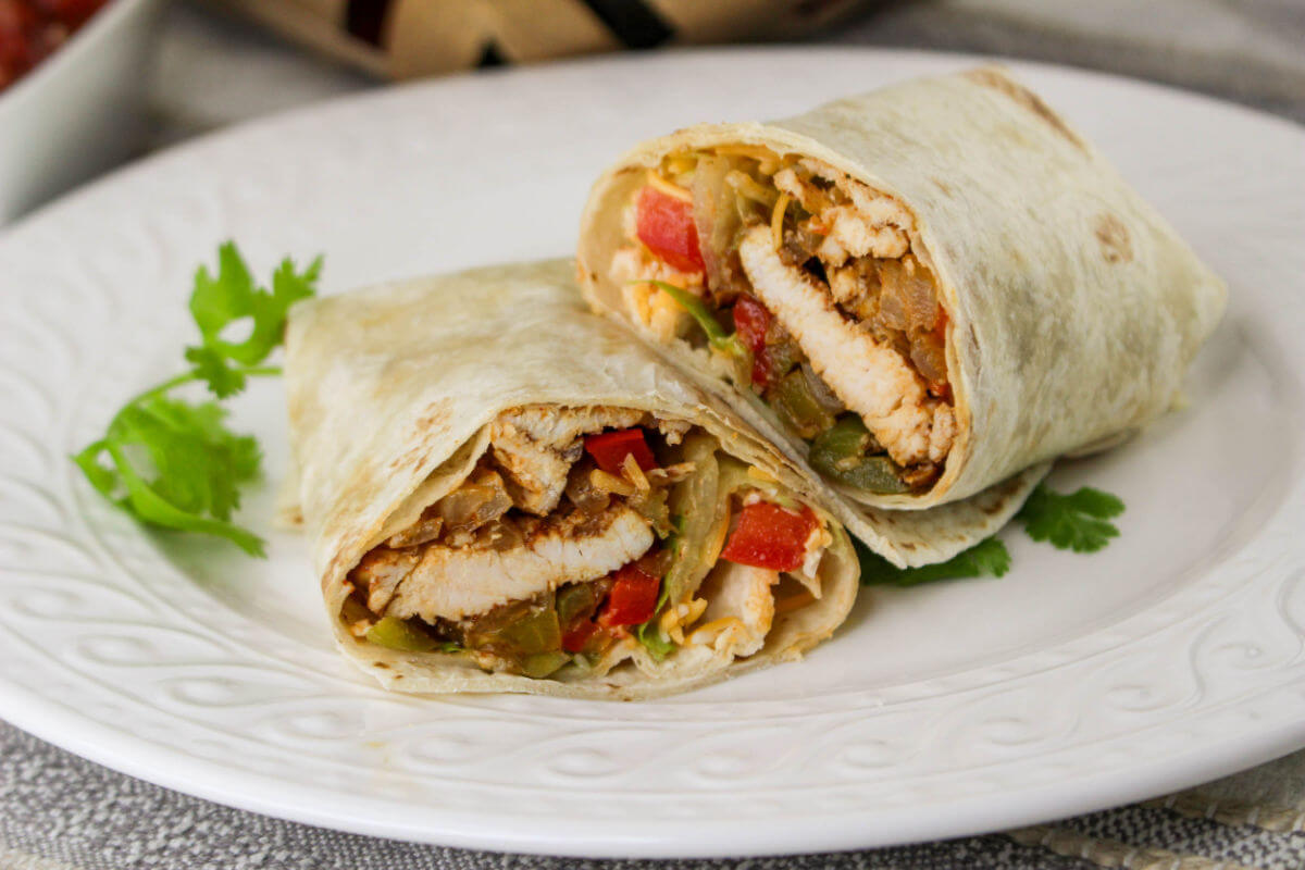 Chicken fajita wraps on a plate.