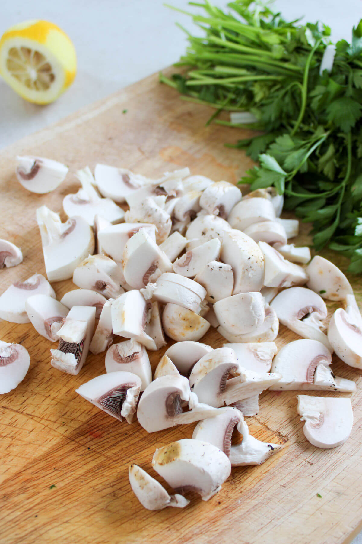 Slicing mushrooms for chicken meatballs with orzo.