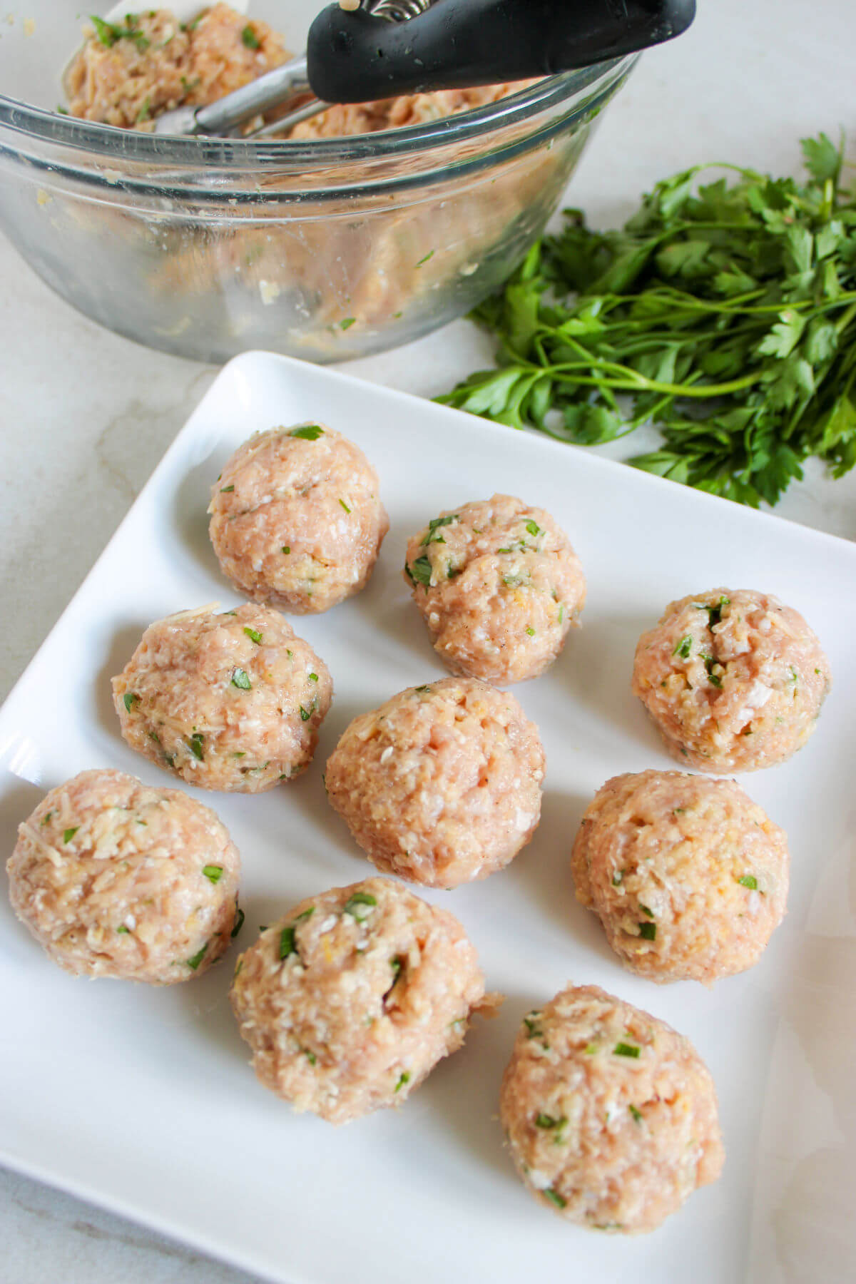 Forming chicken meatballs.