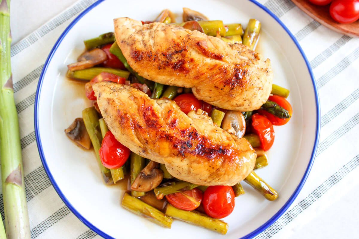 One pan chicken and vegetables on a serving plate.