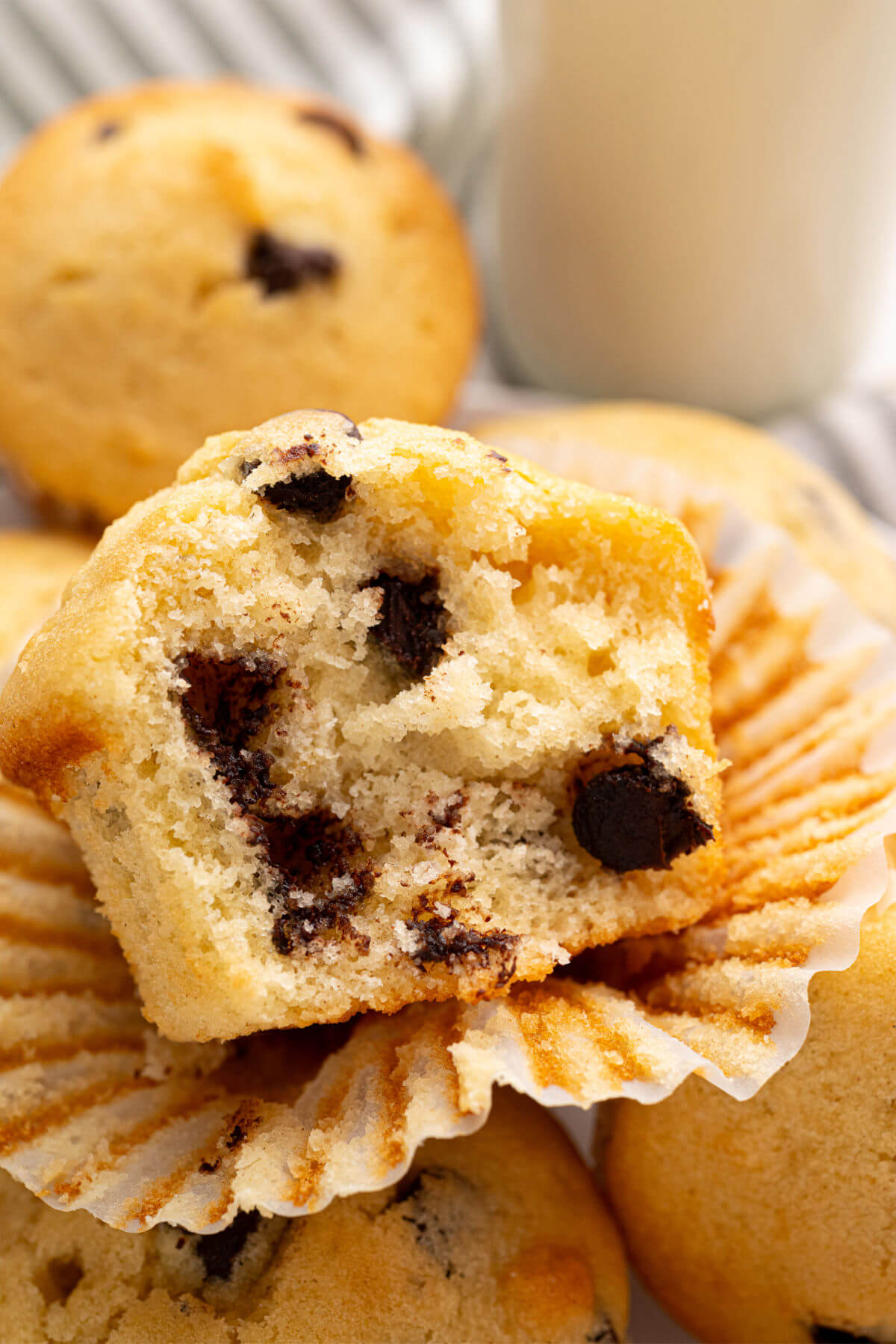 A partially eaten sourdough chocolate chip muffin.