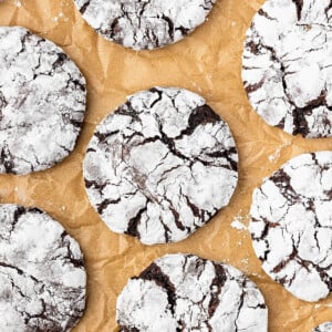 Sourdough chocolate crinkle cookies on parchment paper.