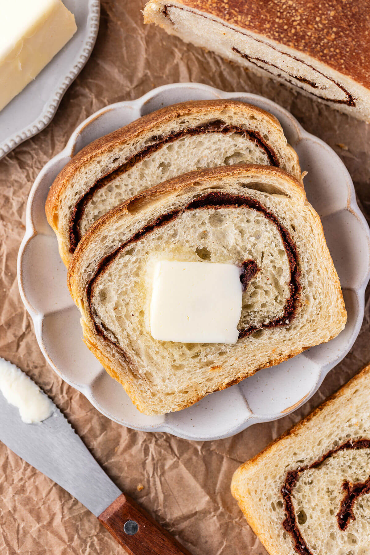 Sourdough cinnamon swirl bread with butter on a slice.