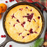 Cranberry orange cobbler in a cast iron skillet.