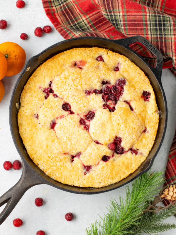 Cranberry orange cobbler in a cast iron skillet.