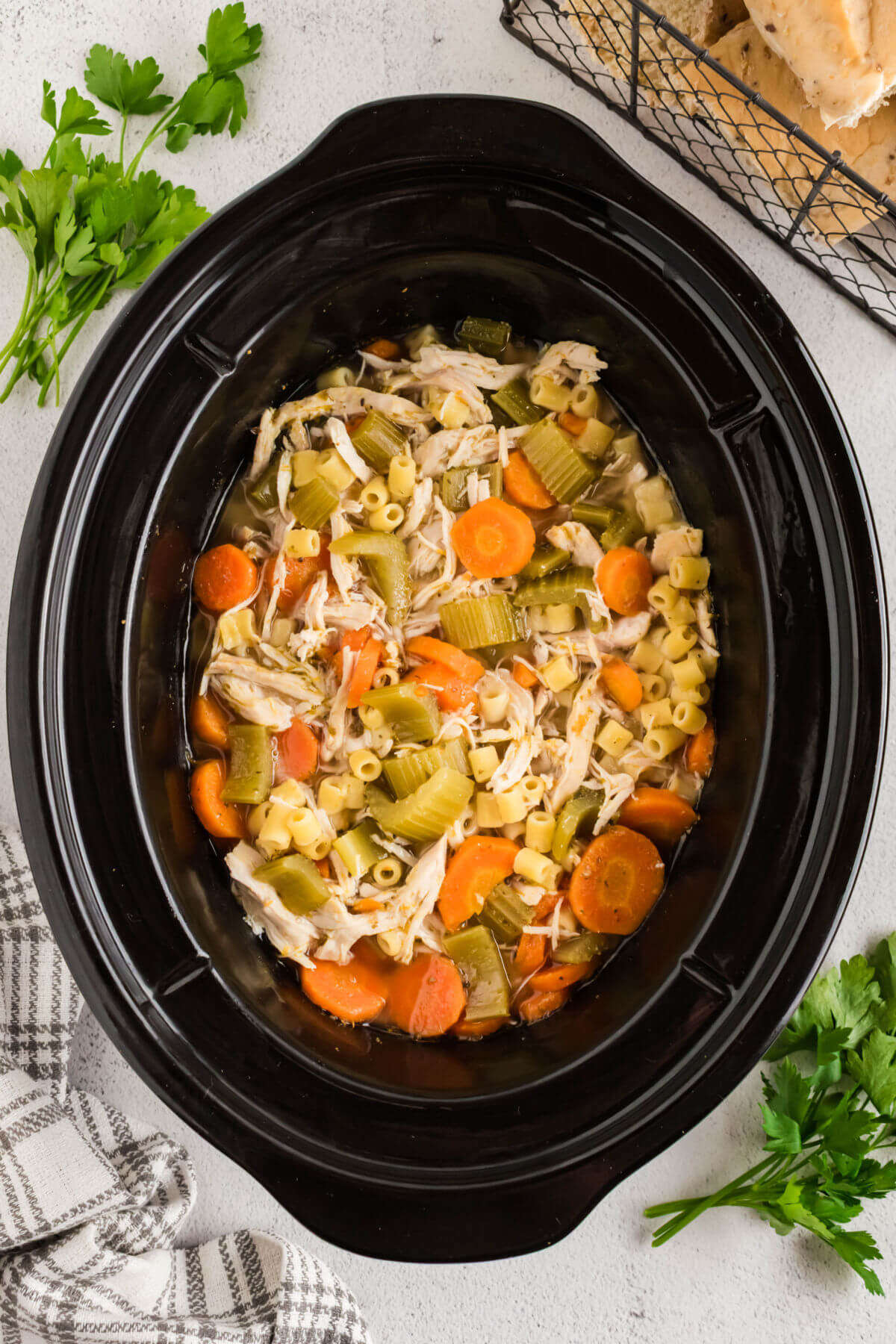 Crock pot chicken noodle soup in a crock pot insert.