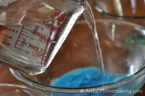 pouring hot water into a bowl of Kool-Aid powder