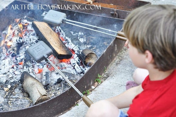 heating hobo pies over a campfire