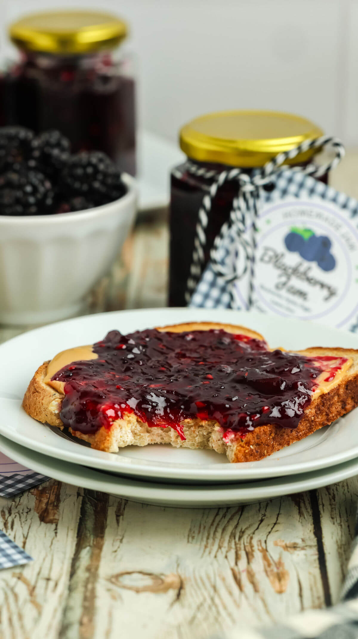 A piece of toast with blackberry jam on top.