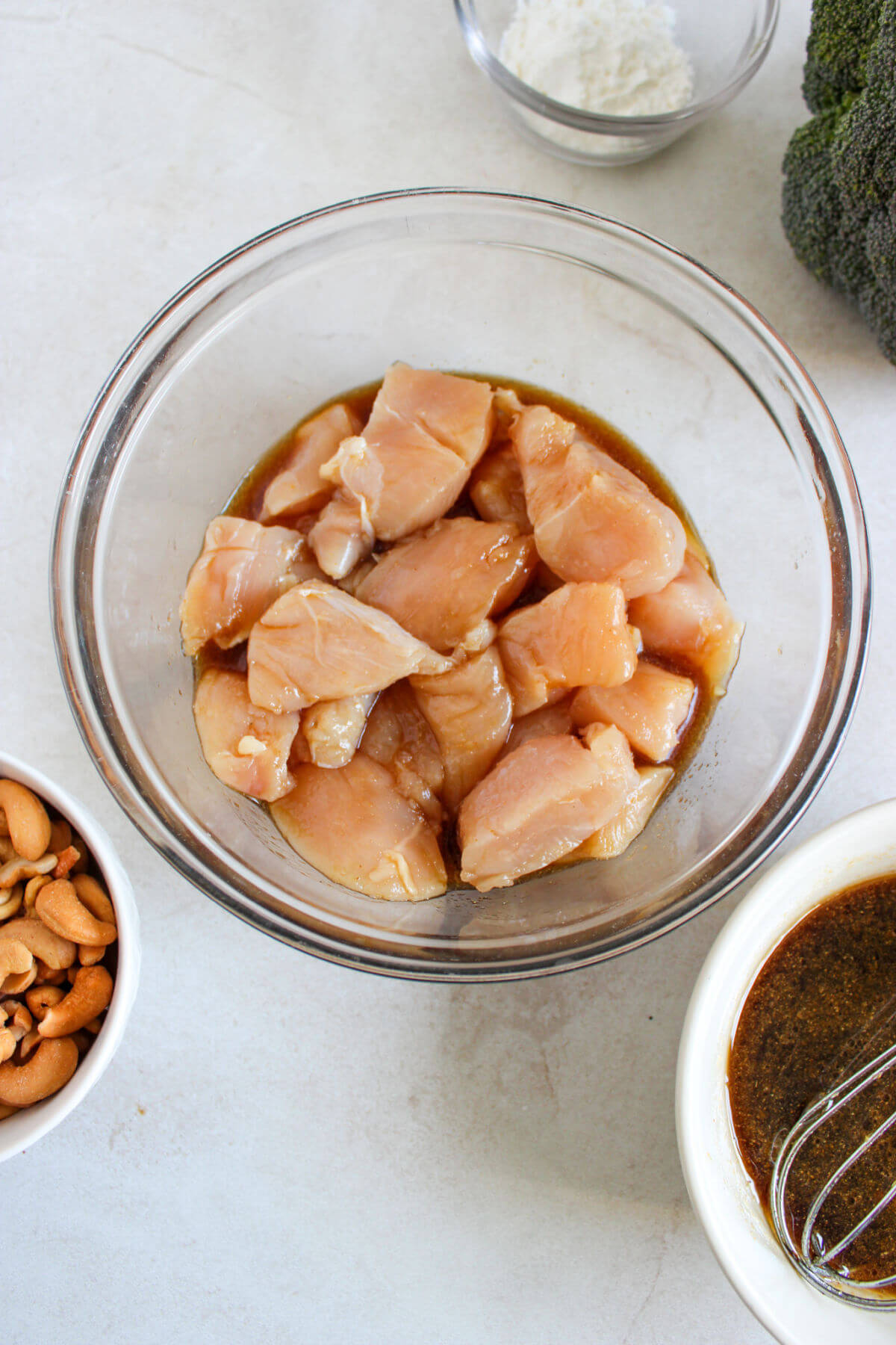 Chicken pieces marinating in the easy cashew chicken sauce.