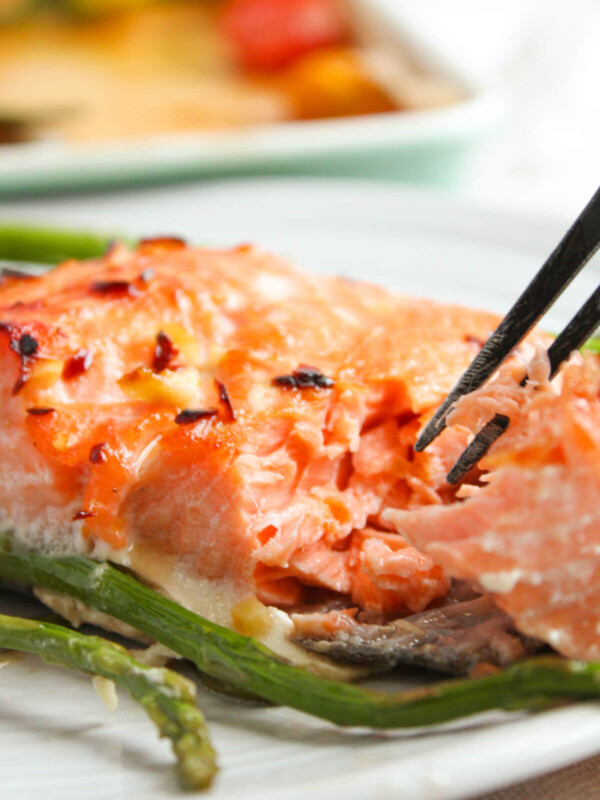 Honey glazed salmon with asparagus on a plate.