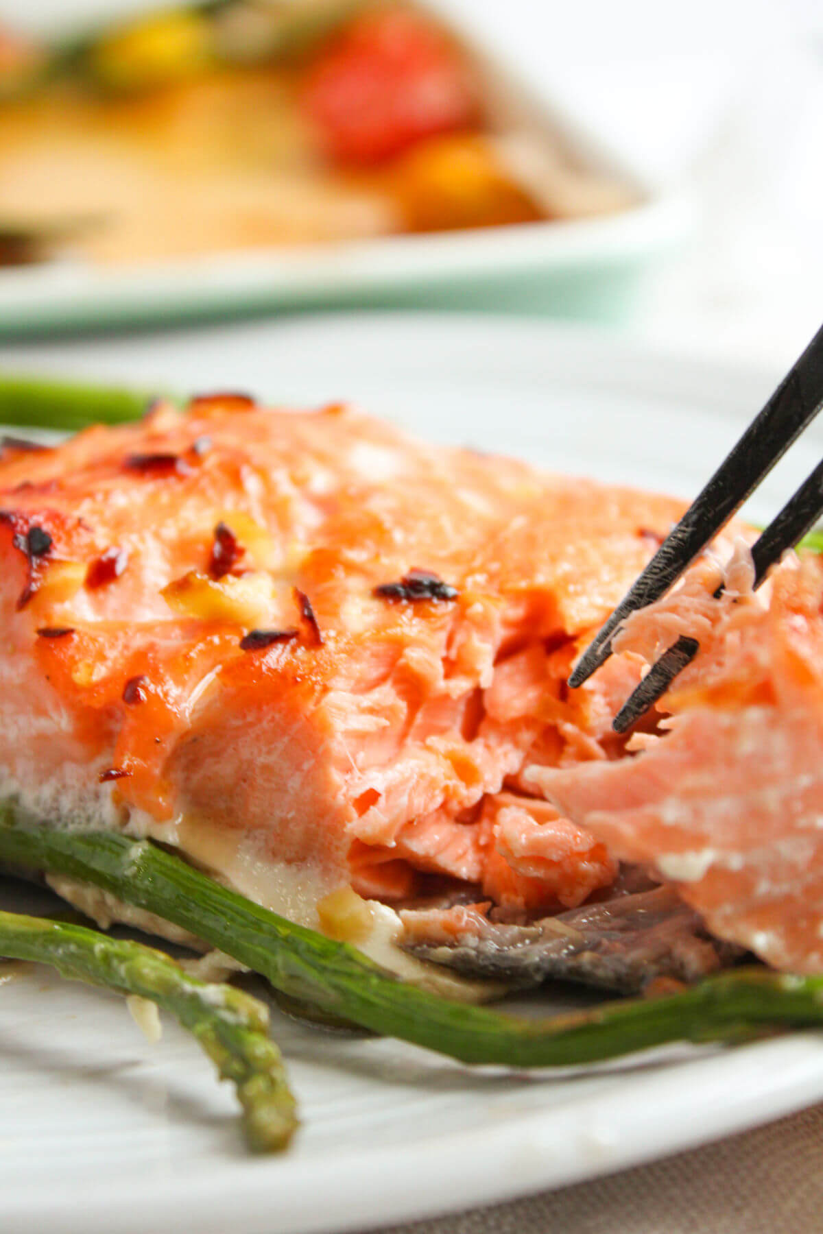 Honey glazed salmon with asparagus on a plate.