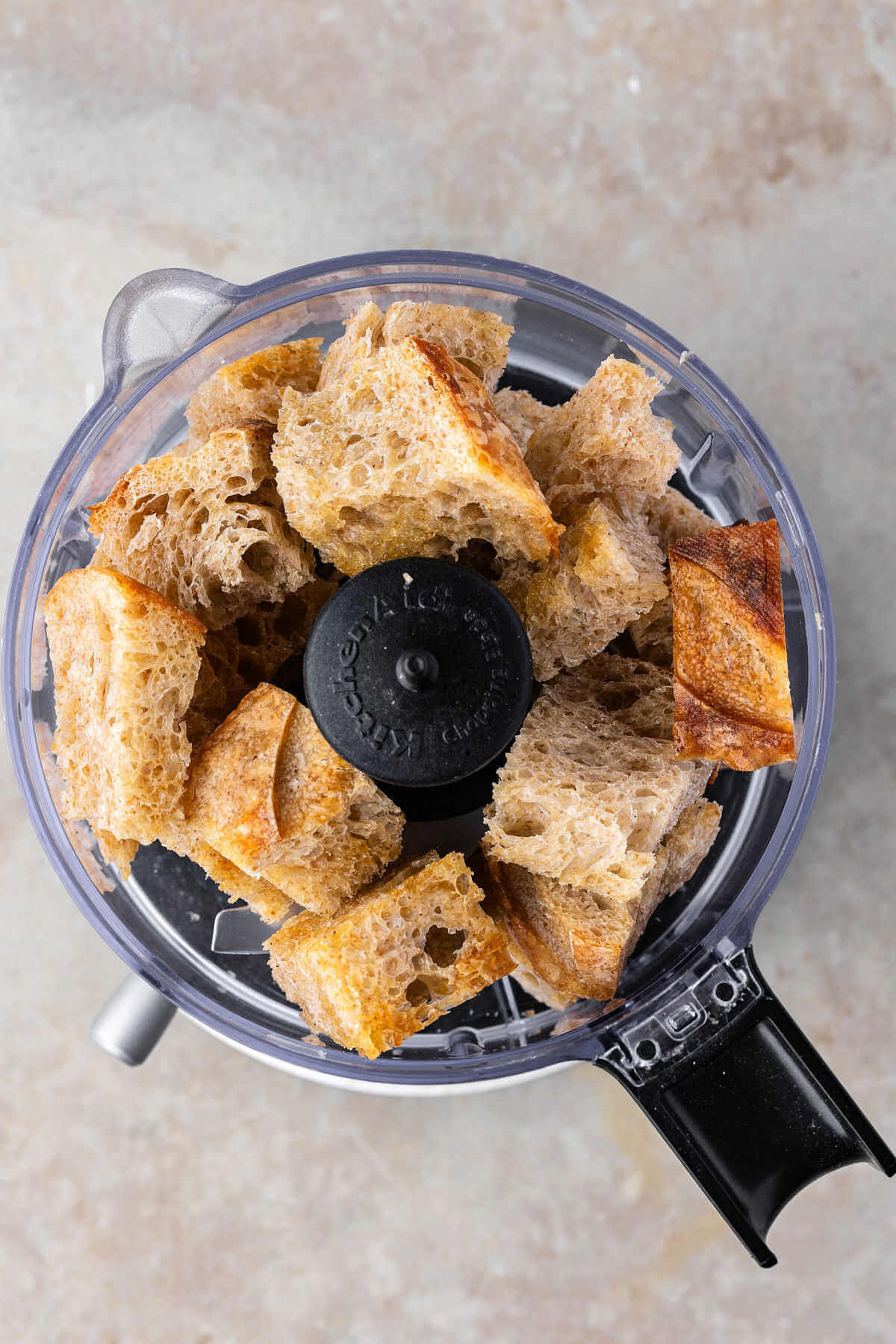 Sourdough bread cubes in a food processor.