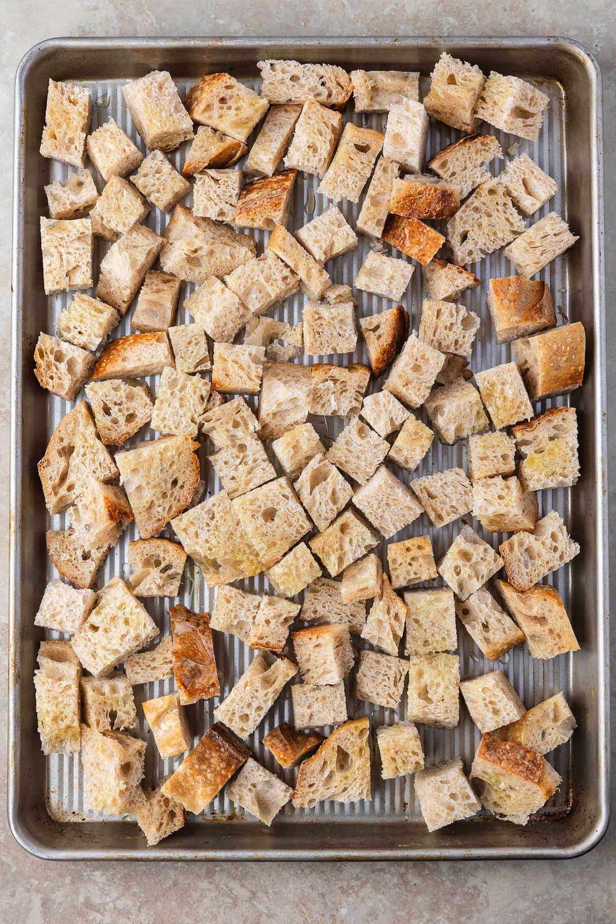 Sourdough bread cubes on a sheet pan.