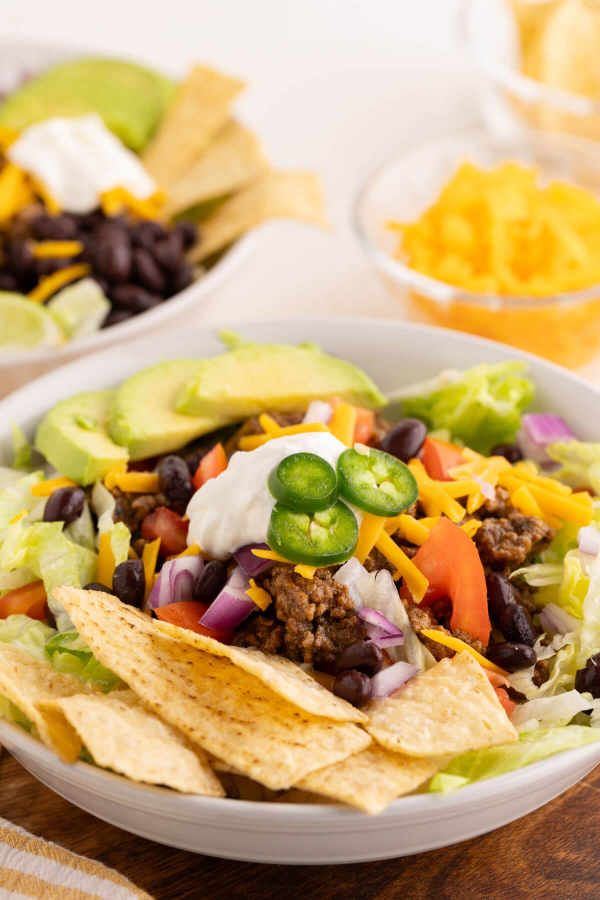 Easy taco salad in a serving bowl with toppings.