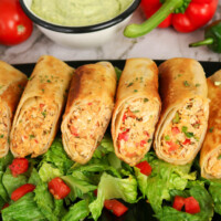 Firecracker chicken wraps on a bed of lettuce.