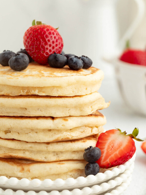 Fluffy sourdough pancakes with berries on top.