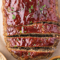 Glazed meatloaf on a piece of parchment.