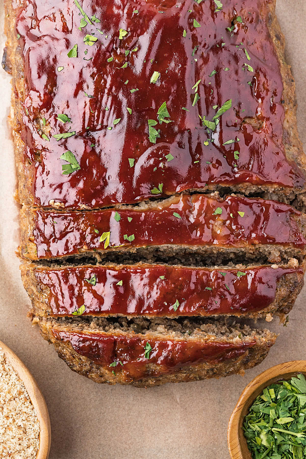 Glazed meatloaf on a piece of parchment.