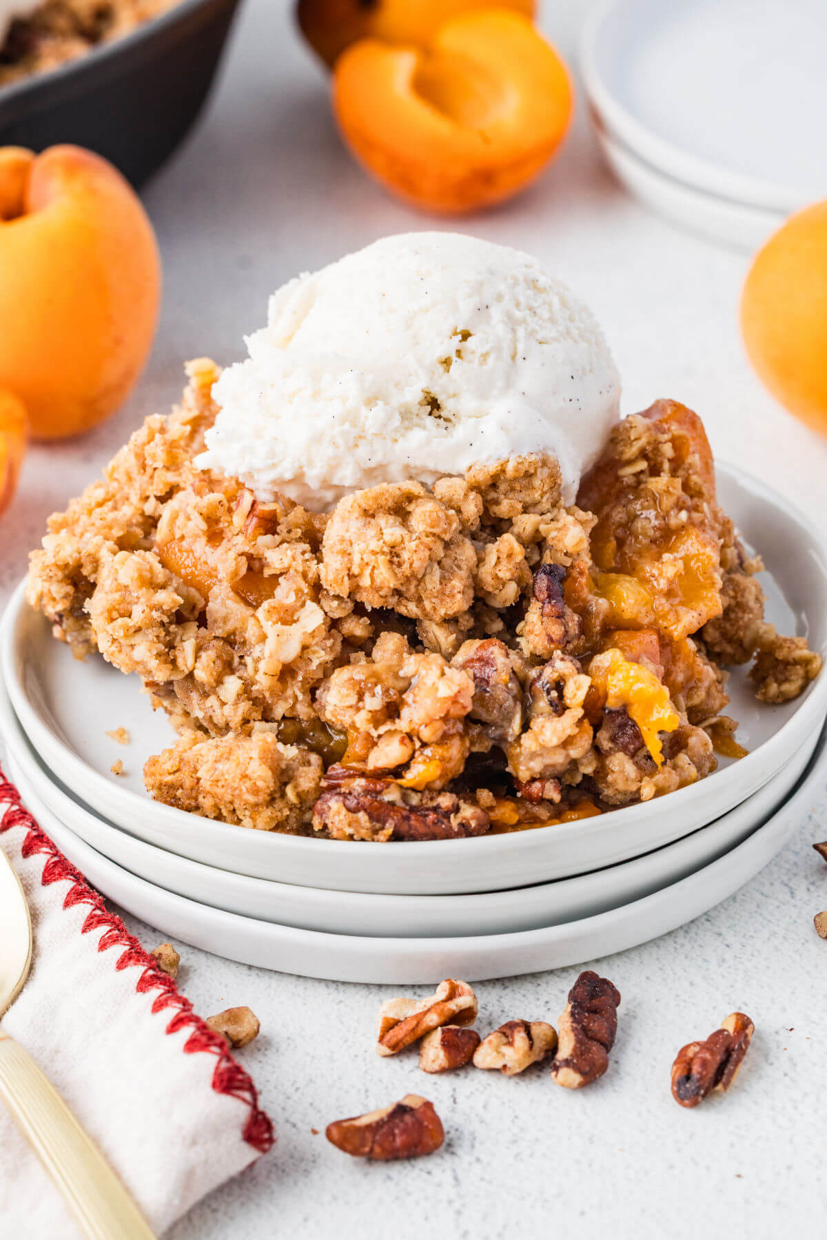 Apricot crumble on a plate with ice cream.