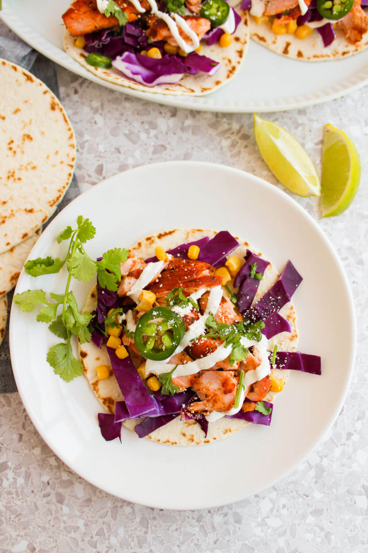 Blackened salmon tacos on a plate.