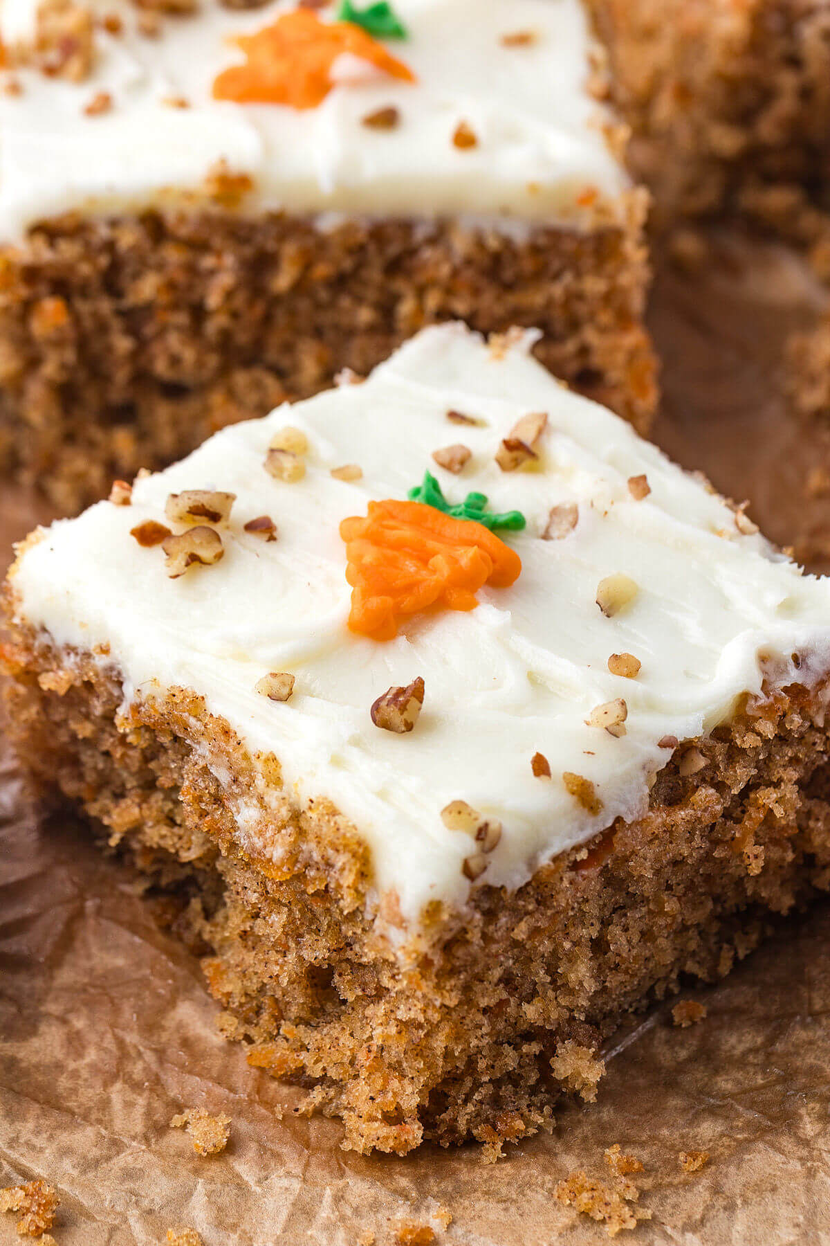 Sourdough carrot cake bars cut into bars and frosted with cream cheese frosting.