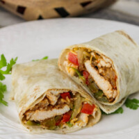 Chicken fajita wraps on a plate.