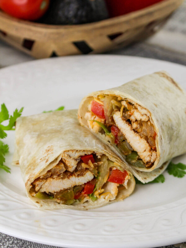 Chicken fajita wraps on a plate.