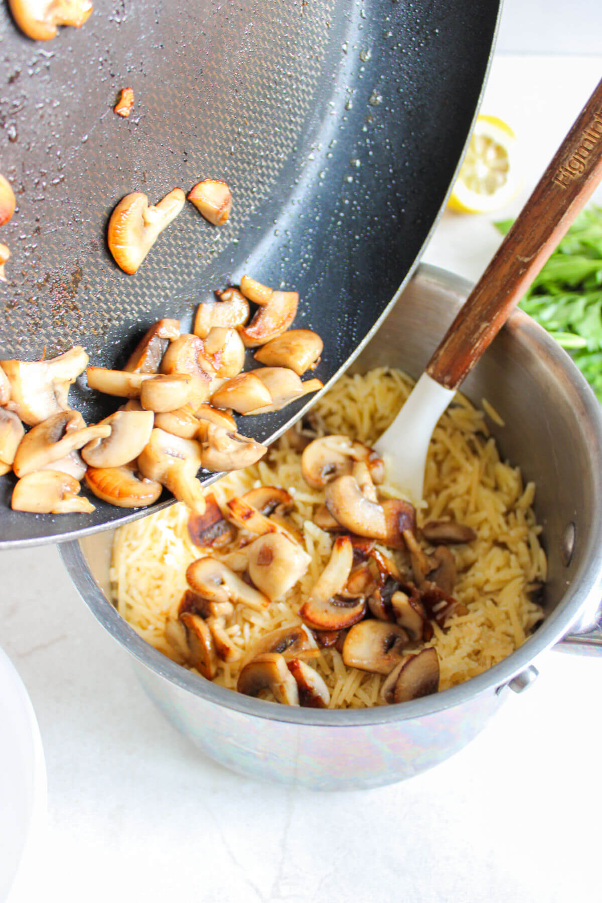Mixing orzo with mushrooms and other ingredients for chicken meatballs with orzo.