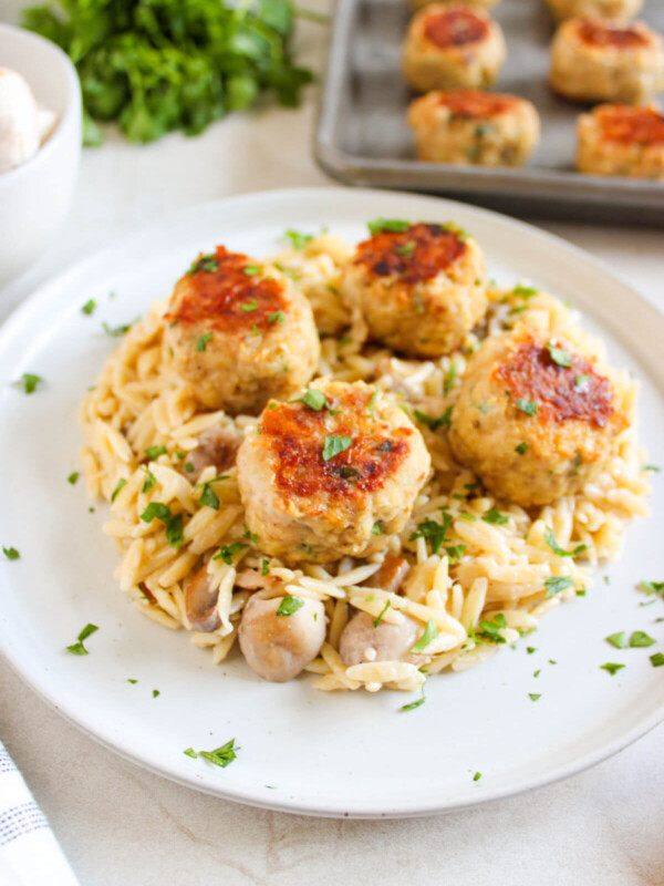 A plate of chicken meatballs with orzo.