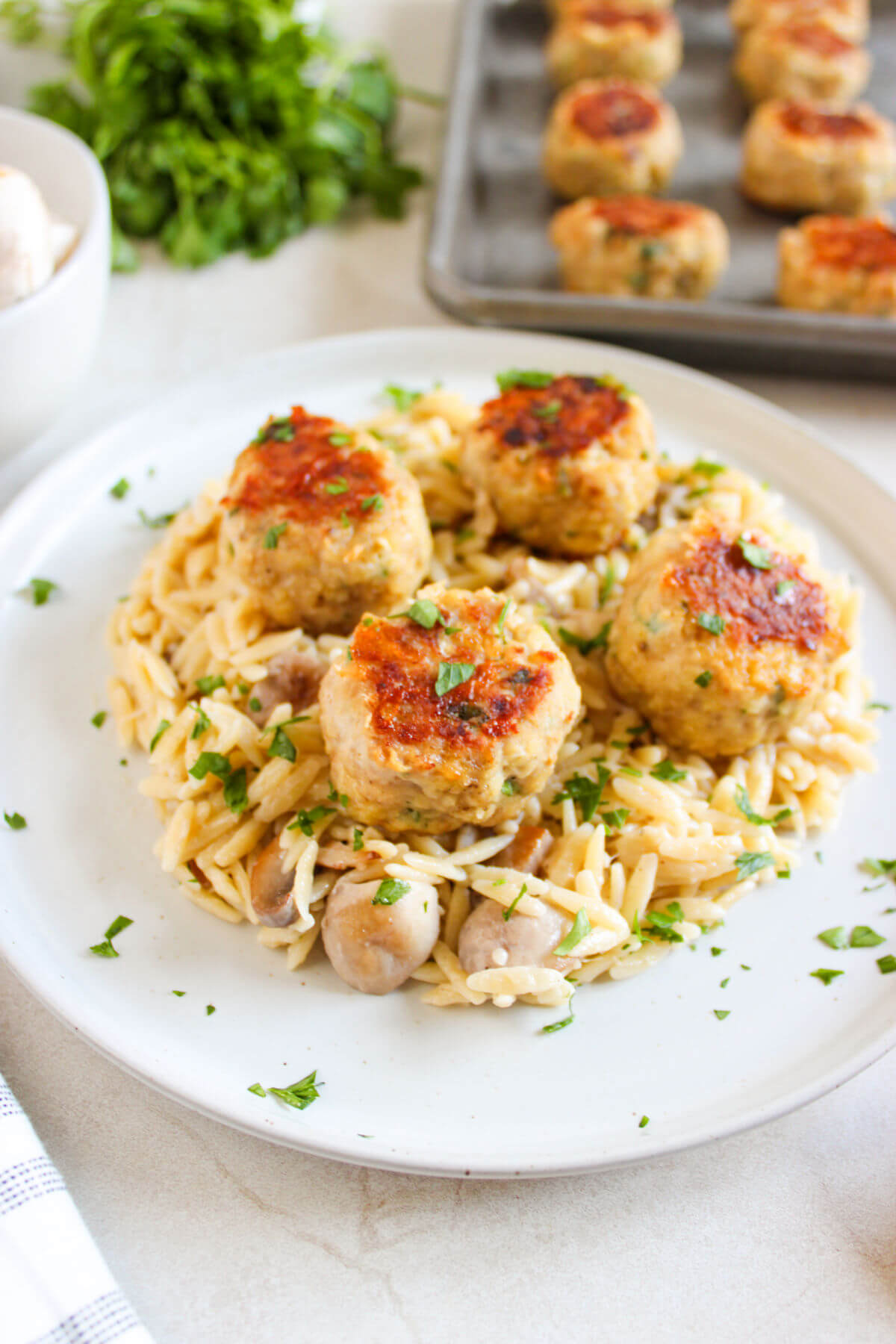 A plate of chicken meatballs with orzo.