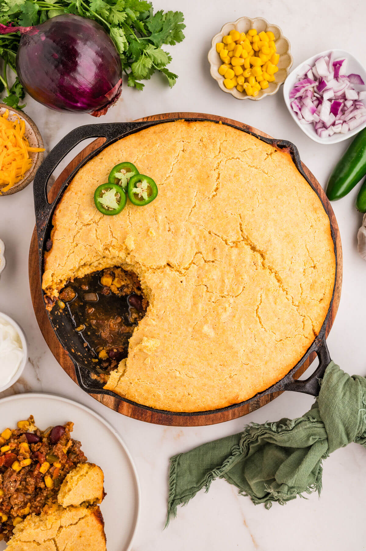 Chili cornbread casserole in a cast iron skillet.