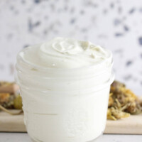 Homemade diaper cream in a glass jar.